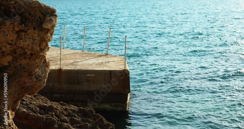 Evening sea waves pier rocks