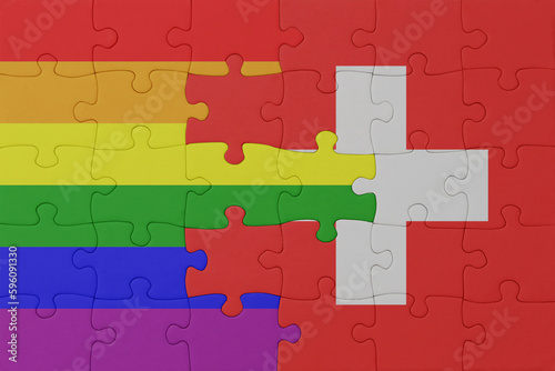 puzzle with the flag of rainbow gay pride and switzerland . macro.concept.