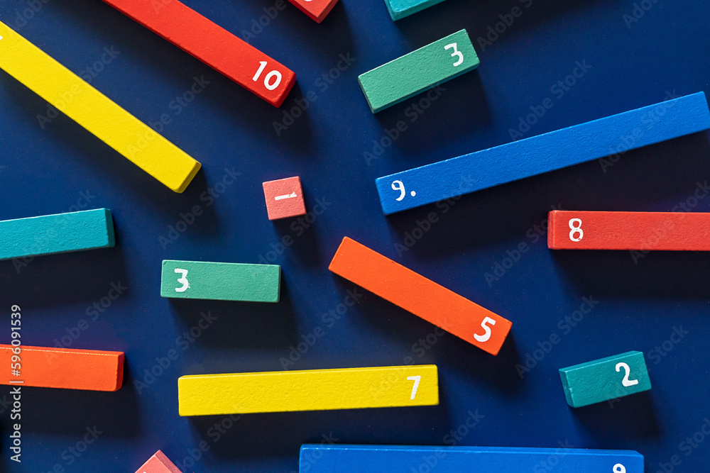 Math fractions on blue background. Interesting math for kids. Education, back to school concept. Geometry and mathematics materials. Close up