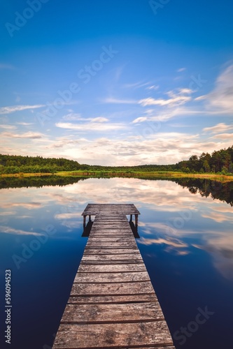 Beautiful summer afternoon landscape by the lake. Charming wooden pier over a small lake in Michala Gora  Poland.