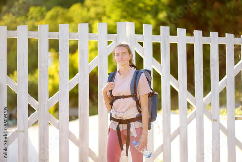 Portrait of young woman hiking in forests and mountains of Europe. Concepts of adventure, extreme survival, orienteering. Solo travel.