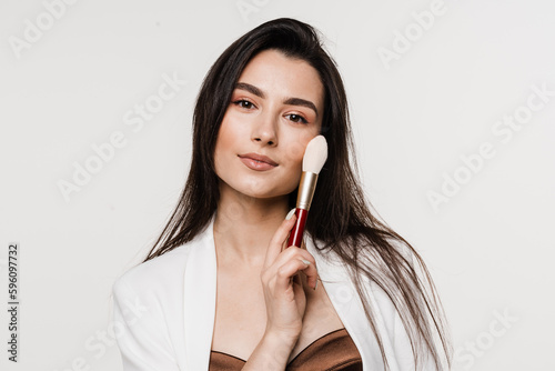 Obraz na plátně Professional make-up artist with makeup brushe on white background