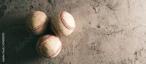Old used baseballs with copy space on grunge concrete texture background.