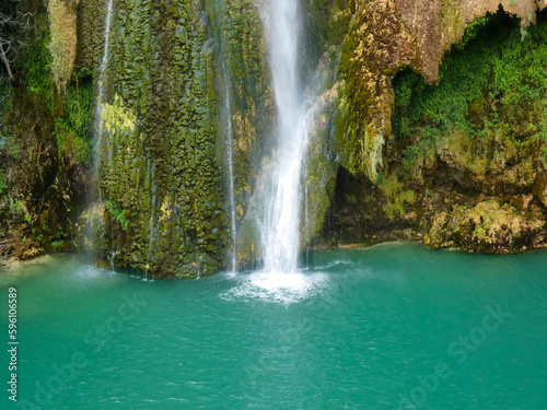 Fototapeta Naklejka Na Ścianę i Meble -  Close-up photo of the end of the Sillans-la-Cascade waterfall in the Var department in Provence in France falling into an expanse of turquoise blue colored water reminiscent of a lagoon