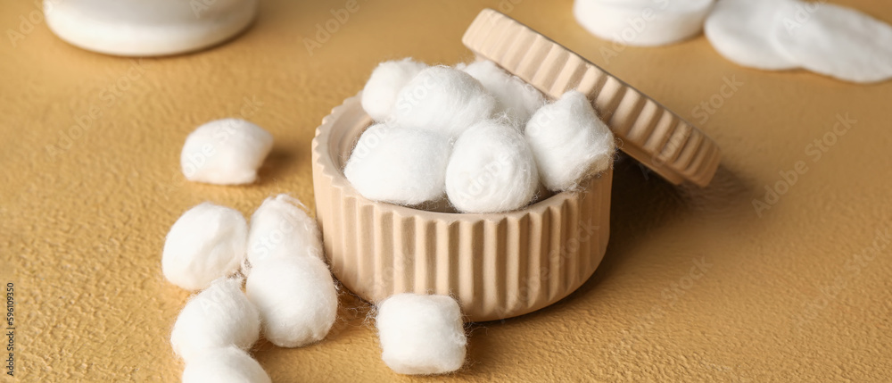 Jar with soft cotton balls on beige background Jar with soft cotton balls on beige background