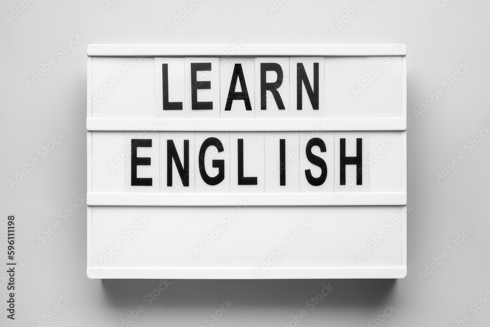 Board with text LEARN ENGLISH on light background Board with text LEARN ENGLISH on light background