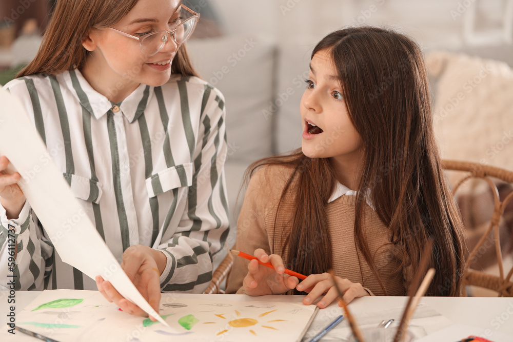Drawing teacher giving private art lesson to little girl at home Drawing teacher giving private art lesson to little girl at home