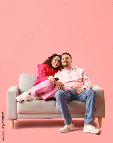 Young couple watching TV on...