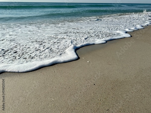 Foamy waves crashing into the seashore 