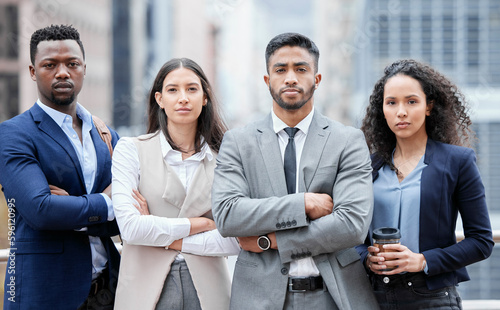 Nothing will stop us from reaching even greater heights. Portrait of a group of confident businesspeople standing with their arms crossed in the city. photo