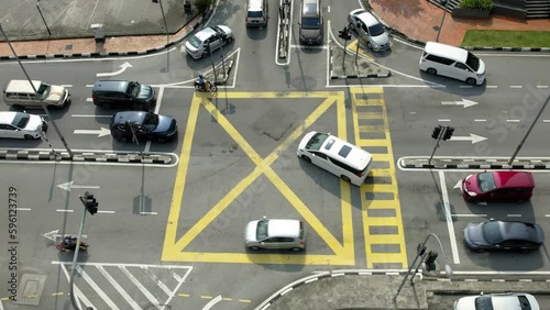 Top aerial view of cars at the intersections in a busy road of Kajang, Selangor, Malaysia. Slow-motion, 4K photo