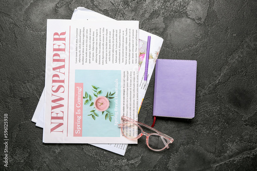 Newspapers with eyeglasses,...