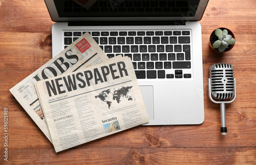Laptop with newspapers and ...