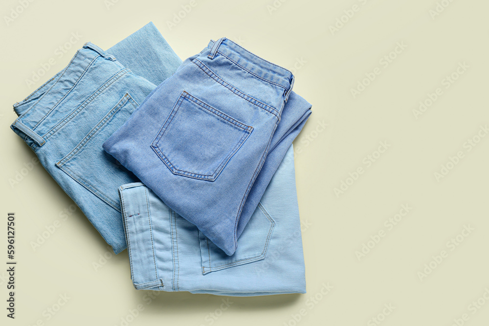 Fototapeta premium Stylish jeans on beige background