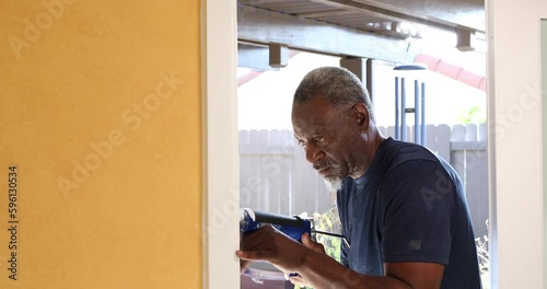 Caulking Gun African American Senior Man Track Right