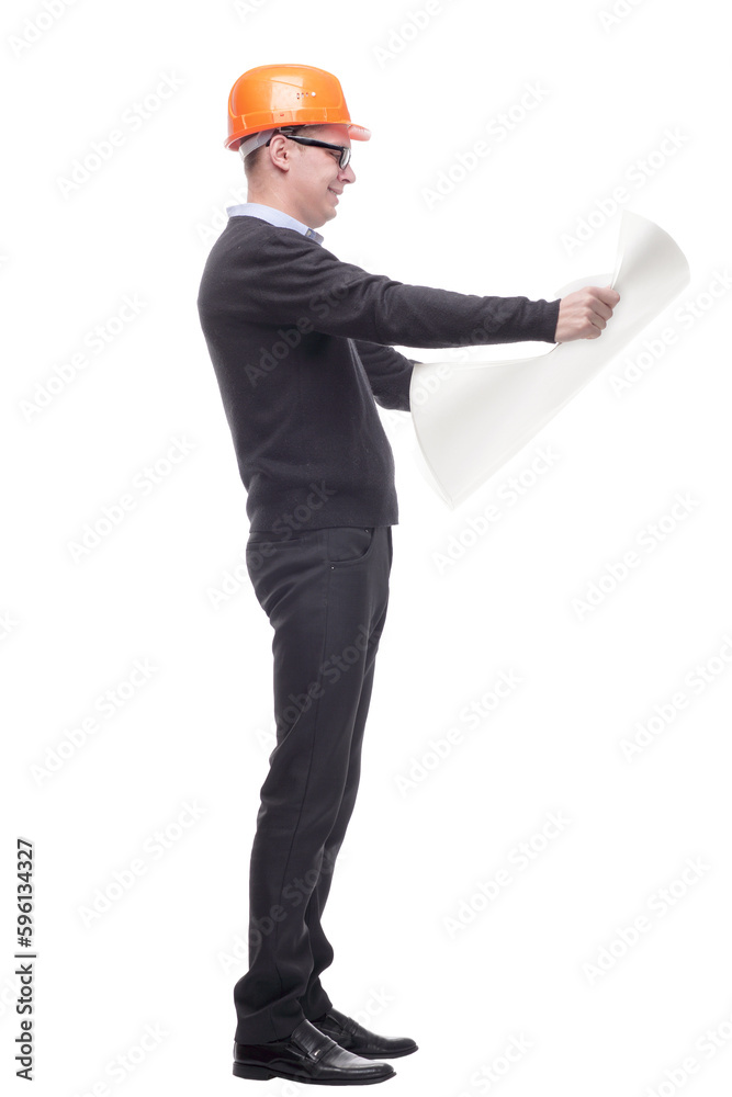 sideview full length portrait of serious businessman in orange hardhat with blueprint looking up sideview full length portrait of serious businessman in orange hardhat with blueprint looking up