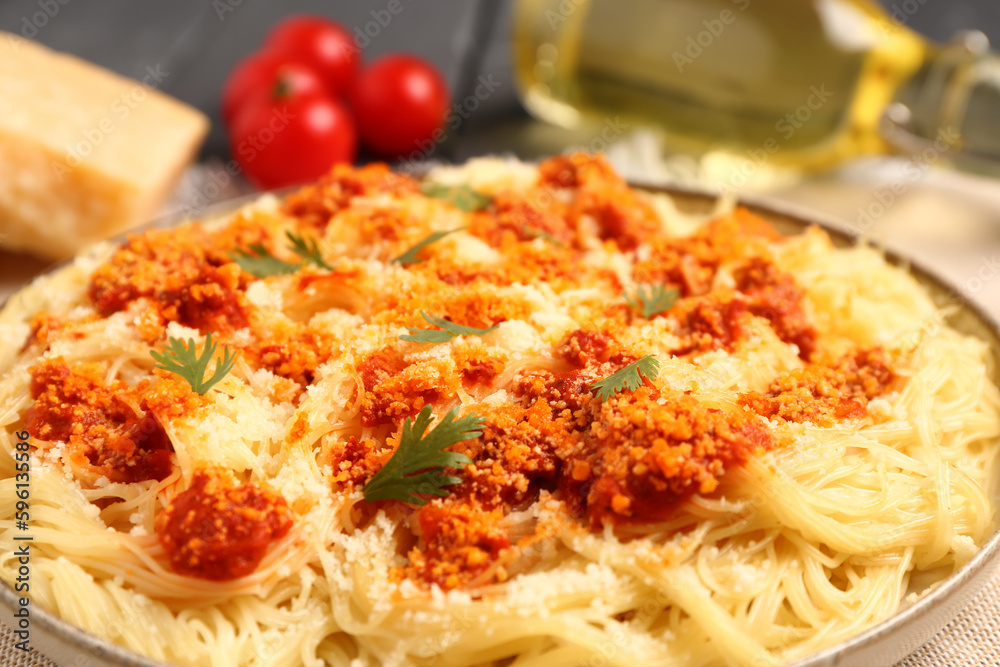 Plate of tasty Italian pasta with Parmesan cheese on table, closeup