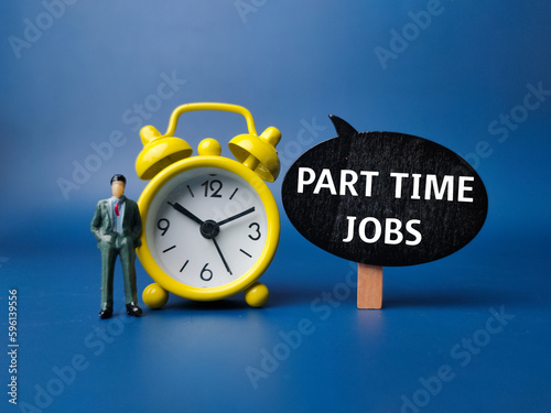 Fotografie Alarm clock and miniature people with the word PART TIME JOBS