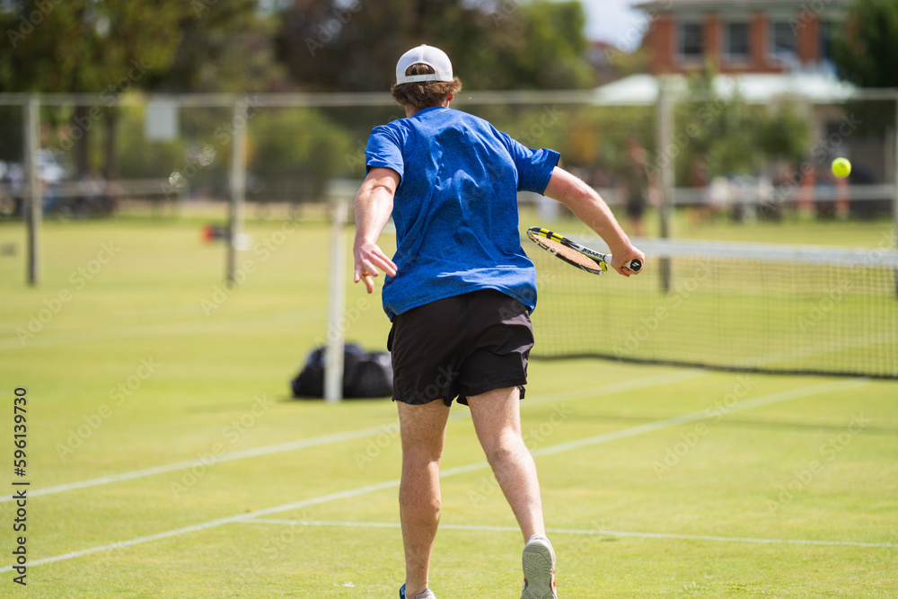 Obraz premium Amateur playing tennis at a tournament and match on grass in Europe 
