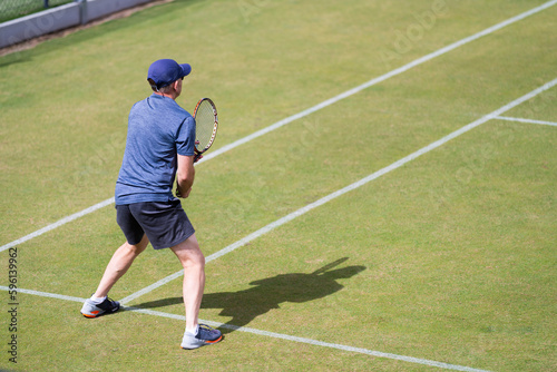 Amateur playing tennis at a tournament and match on grass in Europe  © Phoebe