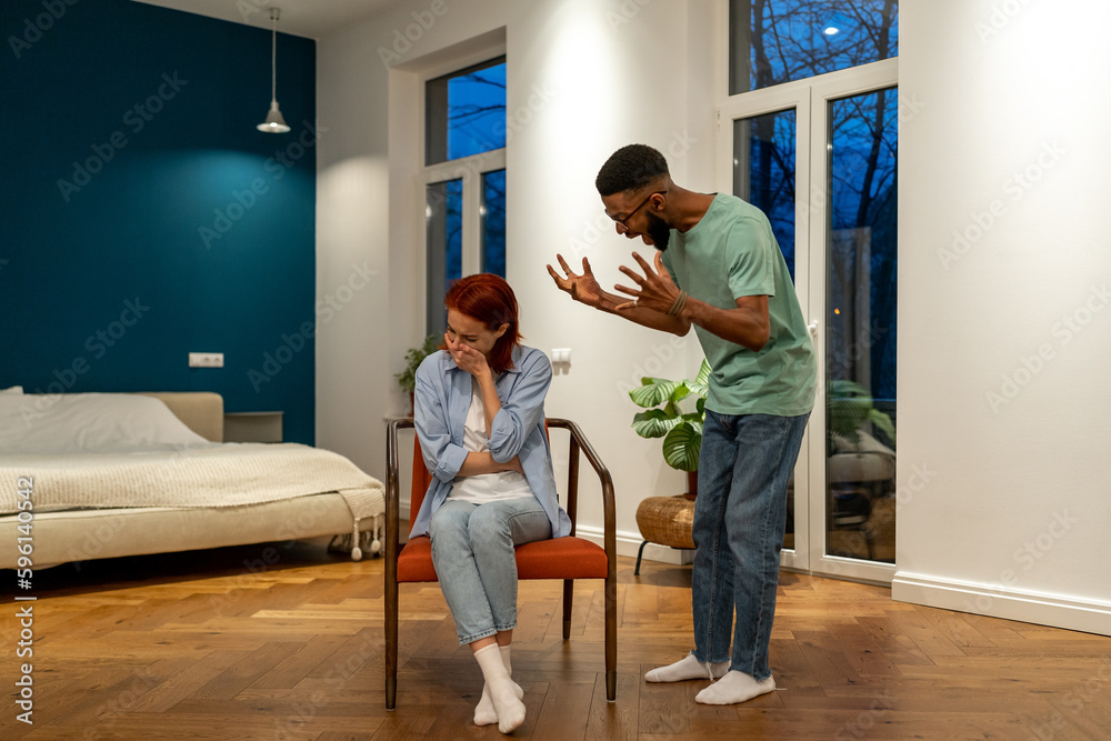 Nervous angry husband african american man screaming try to explain prove something to hysterical stressed european woman wife. Diverse family couple have home conflict. Abuse, psychological pressure Nervous angry husband african american man screaming try to explain prove something to hysterical stressed european woman wife. Diverse family couple have home conflict. Abuse, psychological pressure