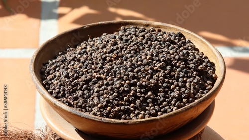 Black pepper in grains. Spice used to season meals, having phytotherapeutic and medicinal benefits.