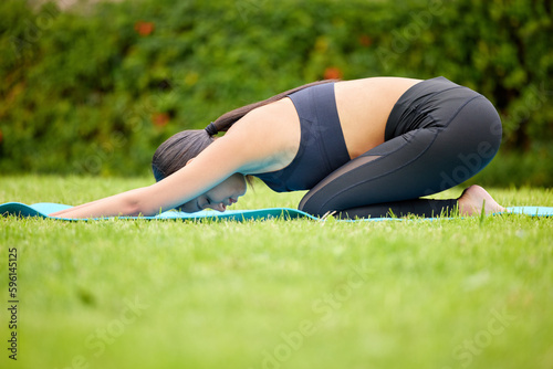 Bend over like you mean it. a young woman doing a downward yoga pose while exercising outdoors. © Daiyaan Philander/peopleimages.com