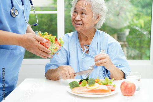 Asian Nutritionist holding healthy food for patient in hospital, nutrition and vitamin.