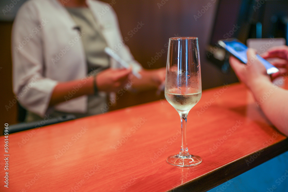 Alcohol at the bar evokes luxury, celebration, and indulgence. Cocktails and champagne symbolize sophistication and socializing, but can also represent excess and addiction