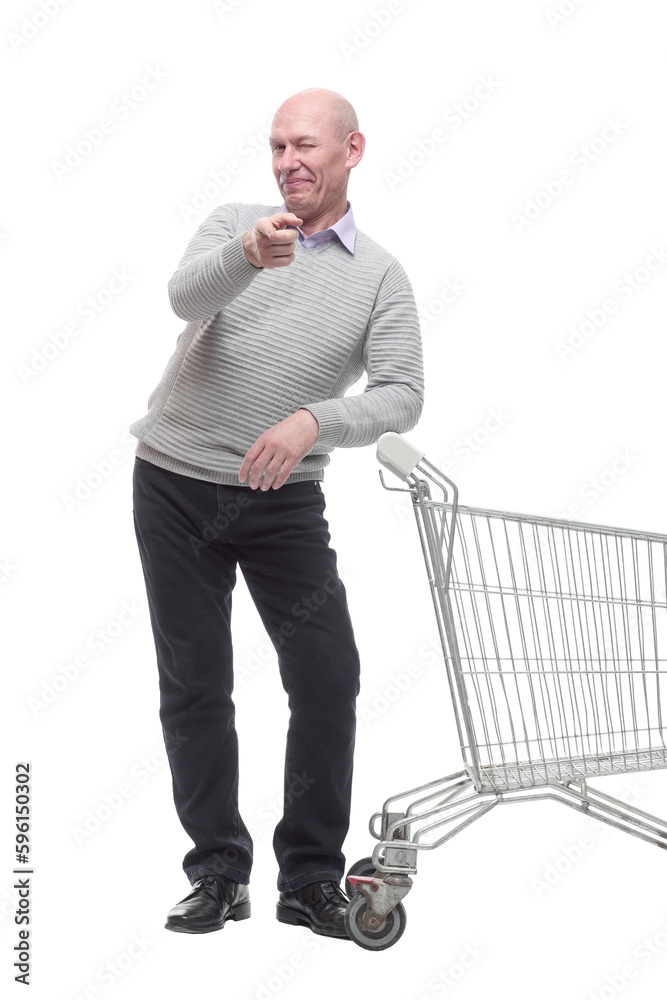 in full growth. a happy man with a shopping cart. in full growth. a happy man with a shopping cart.