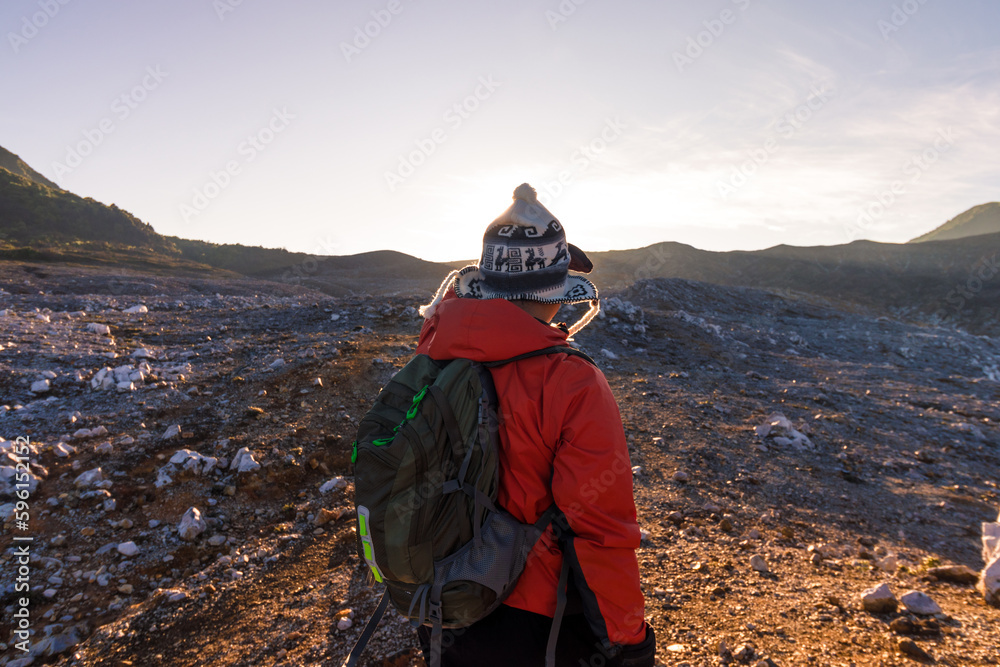 male hiker contemplating the rocky landscape in Volcan Poas National Park in Alajuela province of Costa Rica