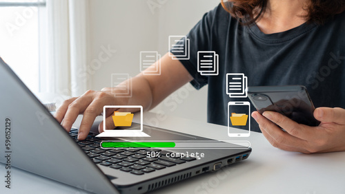 Transfer file concept. data transfer between Smartphone and Laptop. Data transfer file between folder, Backup data, Exchange of file. Virtual document loading to another folder. Streaming download. photo
