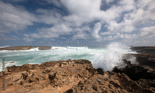 Sunny day with storm waves crashing into Laie Point coastline at Kaawa on the North Shore of Oahu Hawaii United States