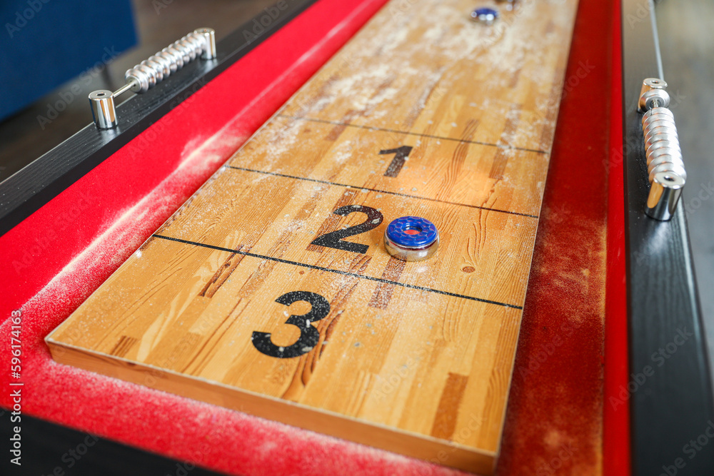 Shuffleboard is a game of precision and strategy, where players slide