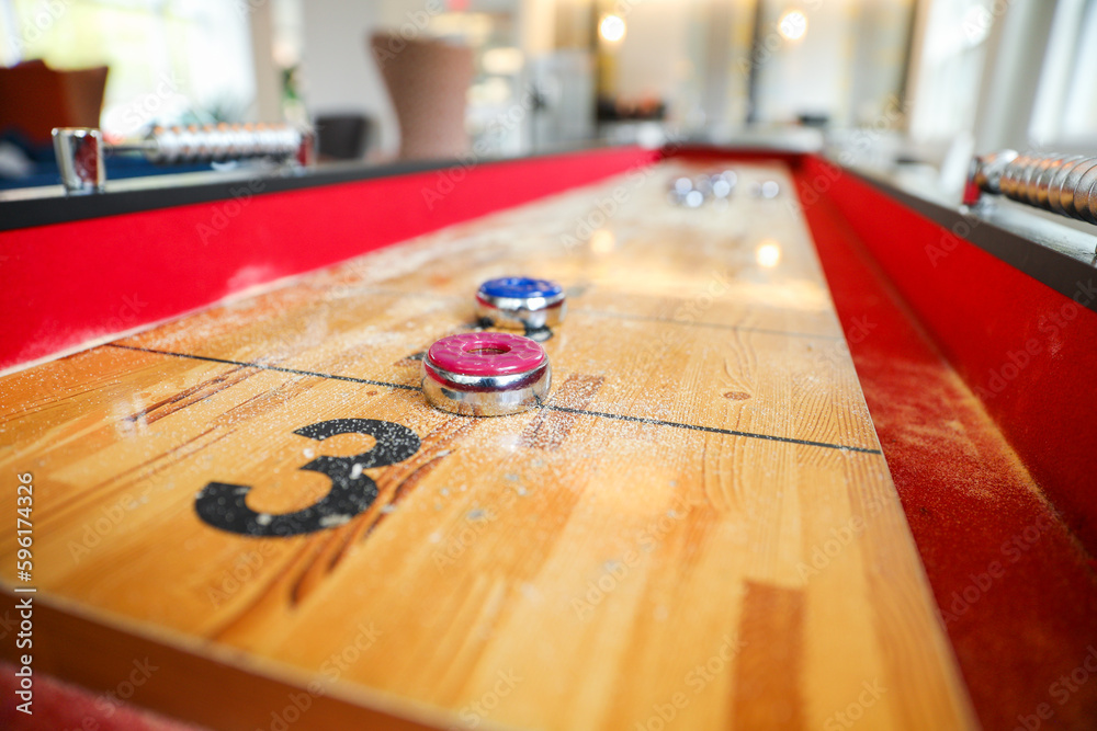 Shuffleboard is a game of precision and strategy, where players slide