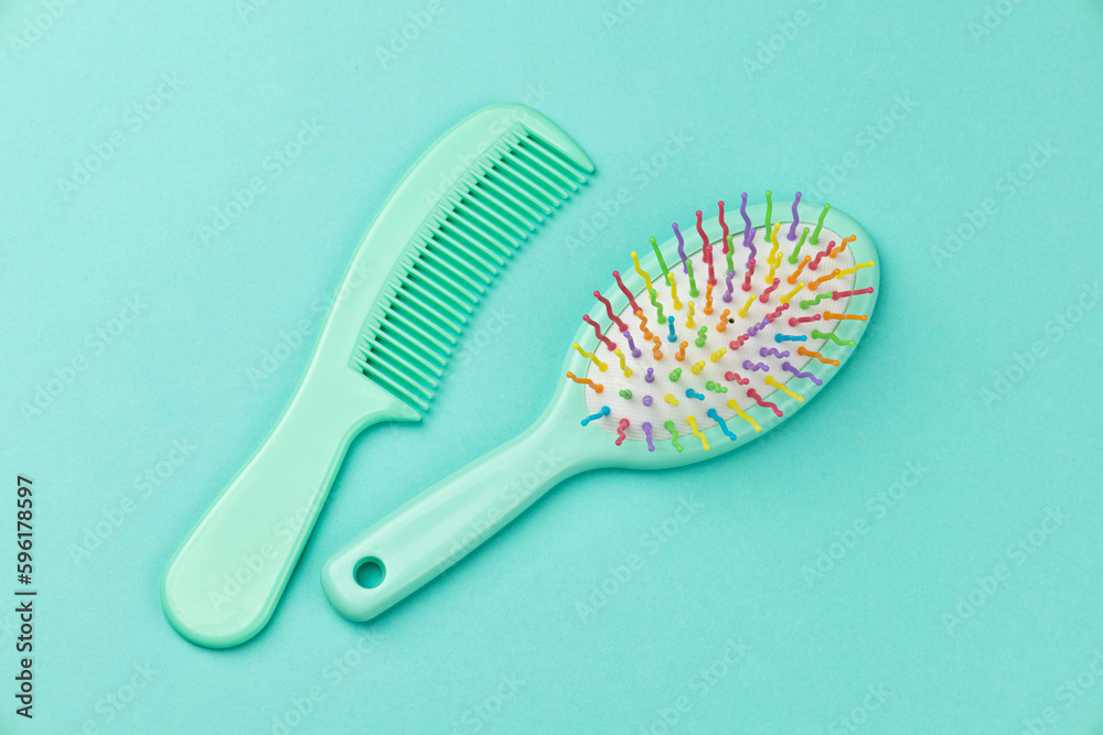 Comb and hairbrush on a green background Comb and hairbrush on a green background