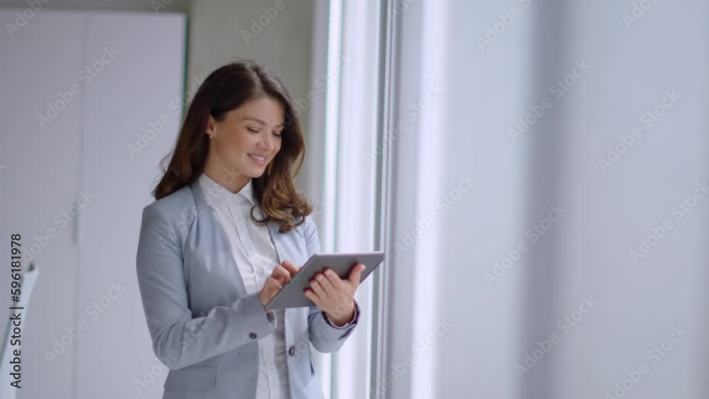 Pretty young woman working on digital tablet in the office hallway Pretty young woman working on digital tablet in the office hallway