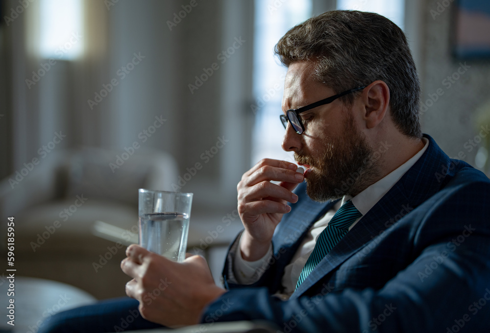 image of business man with headache painkiller. business man with headache taking painkiller pills. image of business man with headache painkiller. business man with headache taking painkiller pills.