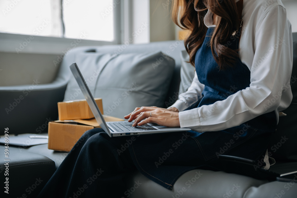 Woman hand using a laptop, smartphone and tablet and writing notebook at the office of her business online shopping. In home . Woman hand using a laptop, smartphone and tablet and writing notebook at the office of her business online shopping. In home .