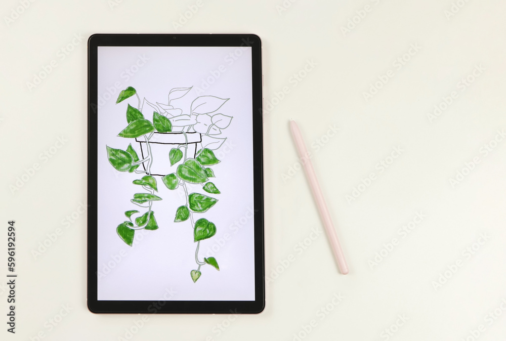 Fototapeta premium flat lay of digital tablet with picture of house plant in watercolor style on screen, pink stylus pen, isolated on white background. Digital art concept.