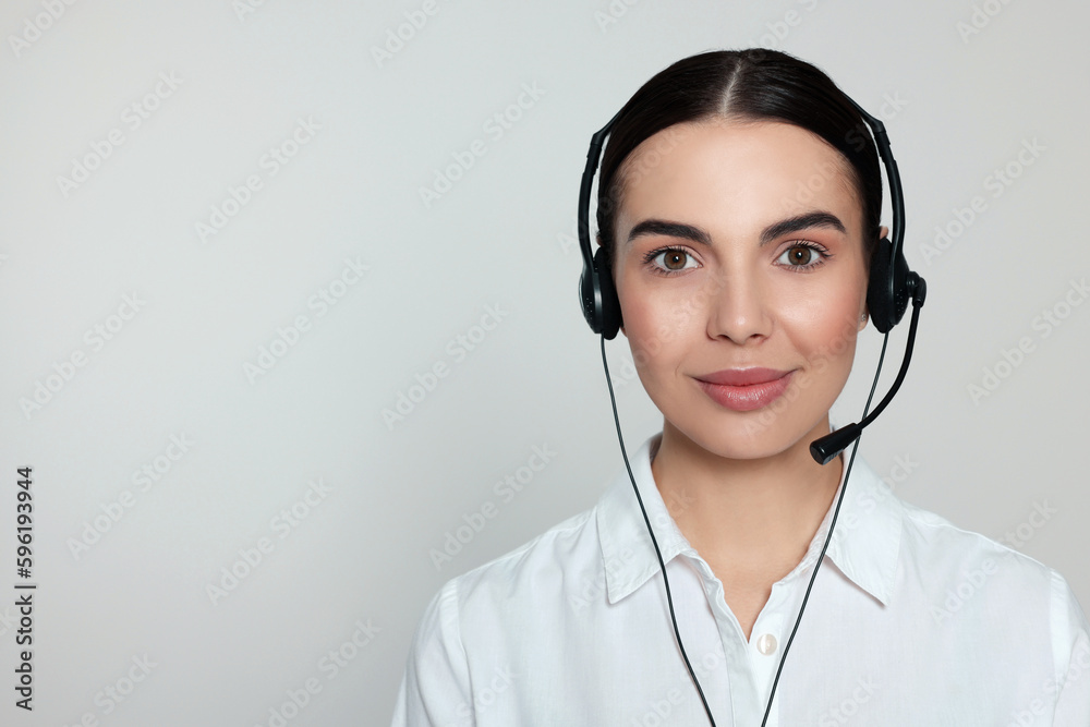 Hotline operator with modern headset on light grey background, space for text. Customer support Hotline operator with modern headset on light grey background, space for text. Customer support