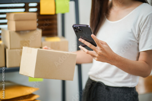 Business From Home Asian woman preparing package delivery box Shipping for shopping online. young start up small business owner at home online order