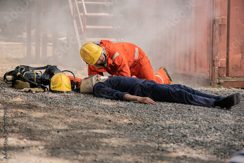The firefighters carefully approached the victims lying on the floor checking for any signs of danger, Saving people.
