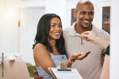 Happy couple, real estate and property with keys from realtor or homeowner for buying, mortgage loan or investment. Man and woman with smile for key to house, moving or sale in new home and paperwork