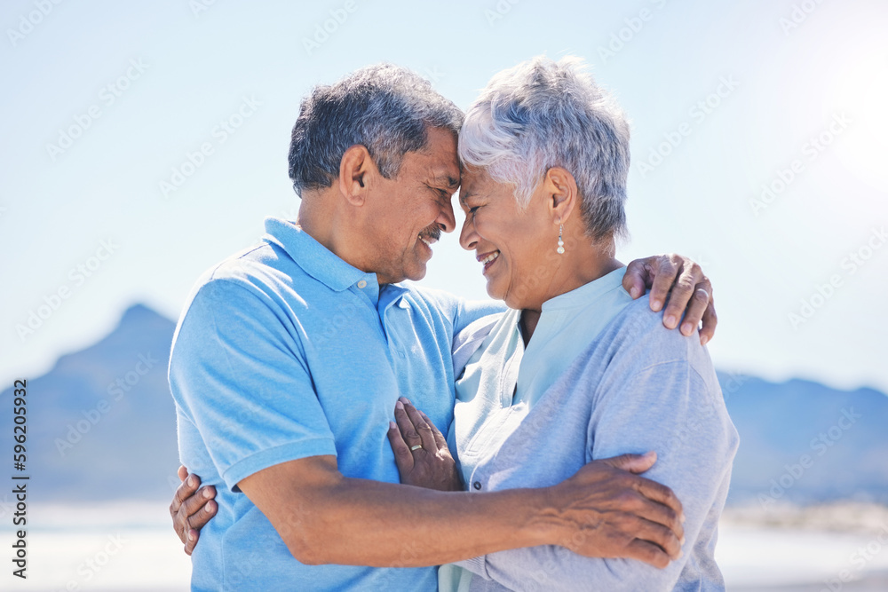 Obraz premium Senior couple, hug and beach love outdoor with support and romance in nature. Ocean, elderly and old woman and man together on summer holiday by the sea feeling happiness and relax on vacation
