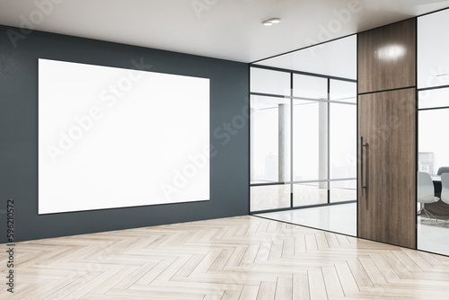 Modern glass office interior with blank white mock up poster on concrete wall, wooden flooring, window and city view. 3D Rendering. © Who is Danny