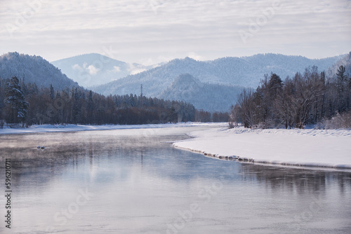 Altai river Biya in winter season. Banks of river are covered by ice and snow. © Serg Zastavkin