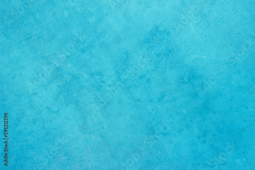 Blue light concrete texture for background in summer wallpaper. Cyan cement colour sand wall of tone vintage. Abstract teal dark color. 