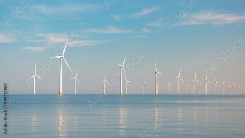  windmill park with a blue sky on a sunny day in the Netherlands, biggest windmill park in the ocean photo