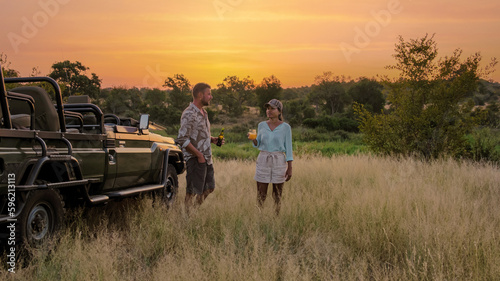 Asian women and European men on safari game drive in South Africa Kruger national park